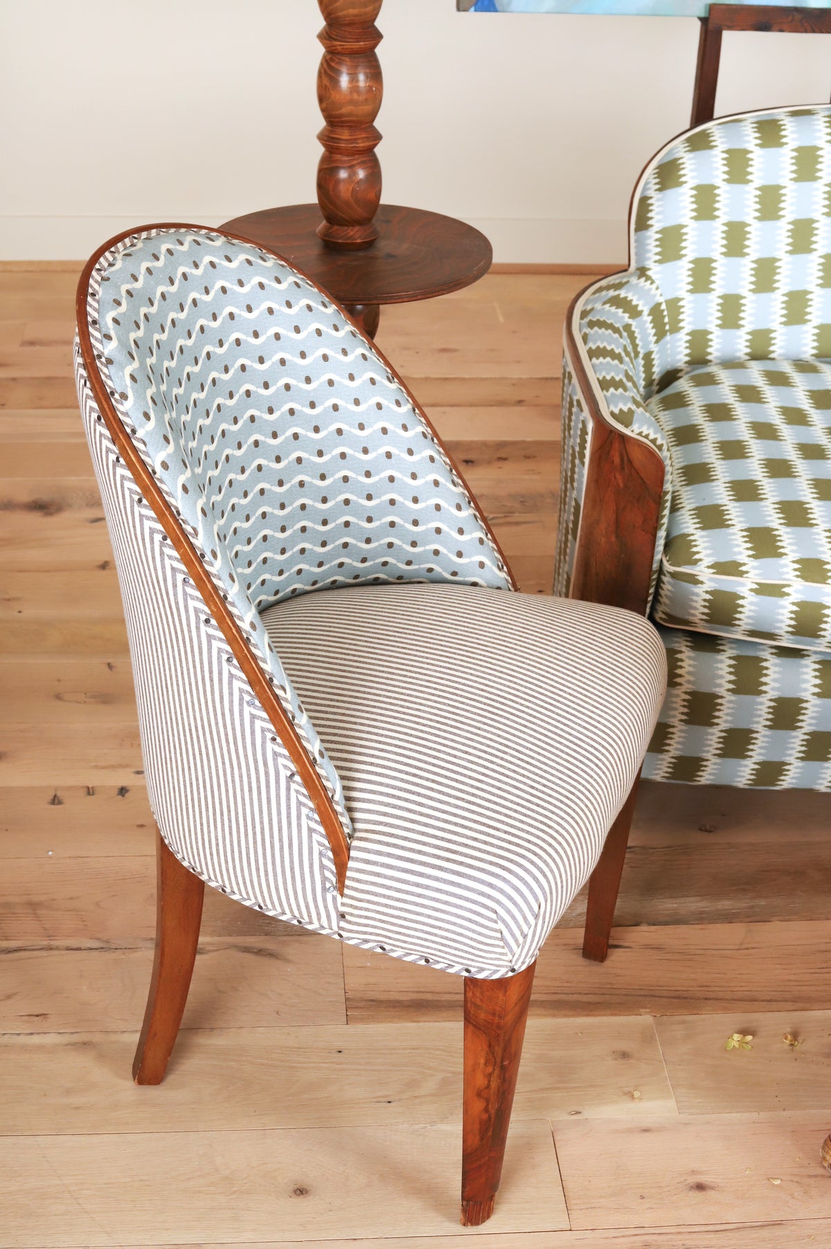 French Art Deco chair with rounded back and exposed wood edge, three-quarter view