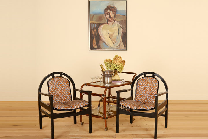 Pair of black lacquered Baumann armchairs in Leah O'Connell Textiles, front