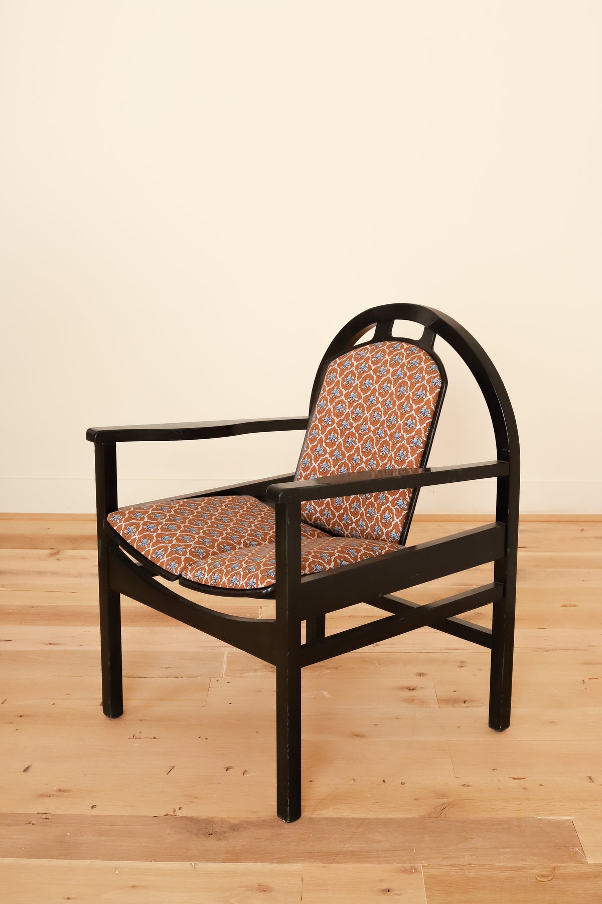Black lacquered Baumann armchair in Leah O'Connell Textiles, three-quarter view