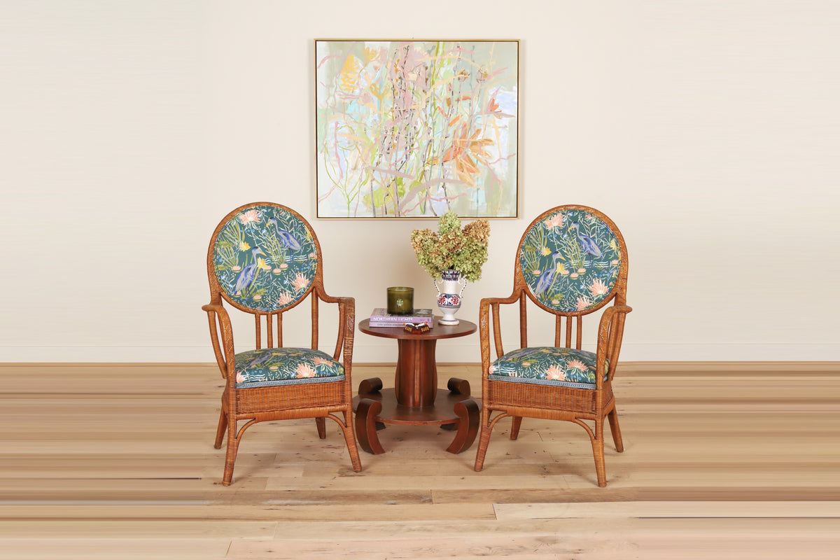 Pair of French rattan armchairs with oval backs c. 1950 in Textiles by Smith, on a wood floor