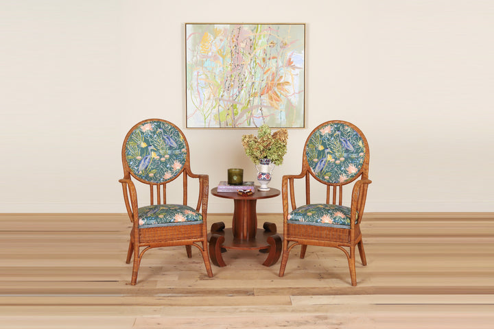 Pair of French rattan armchairs with oval backs c. 1950 in Textiles by Smith, on a wood floor
