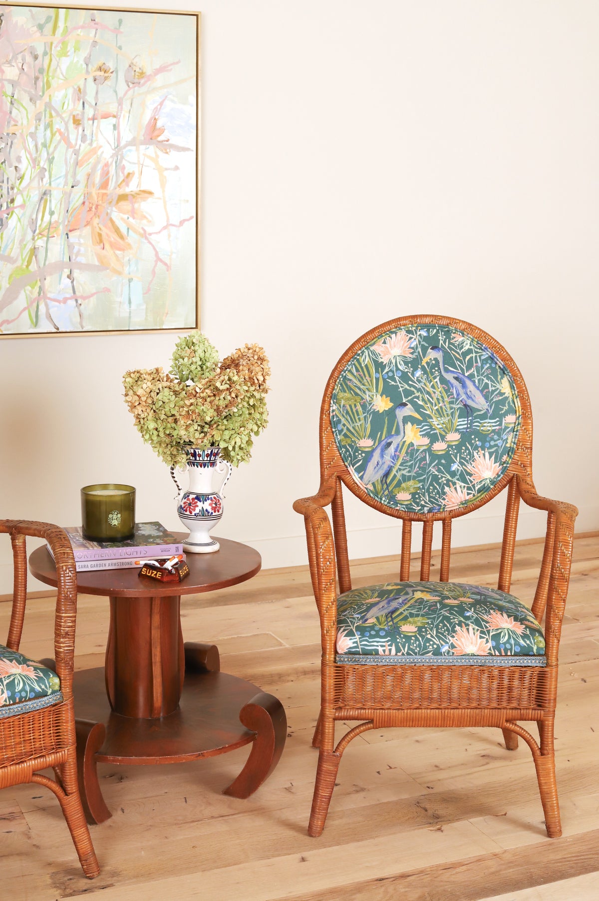 French rattan armchair with oval medallion back, styled beside a side table