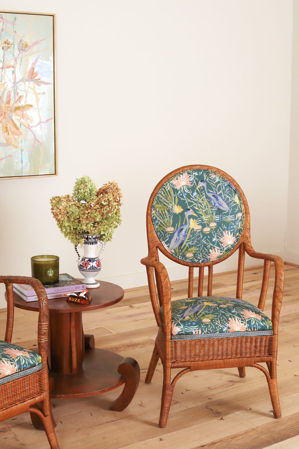 French rattan armchair with curved open arms, three-quarter view