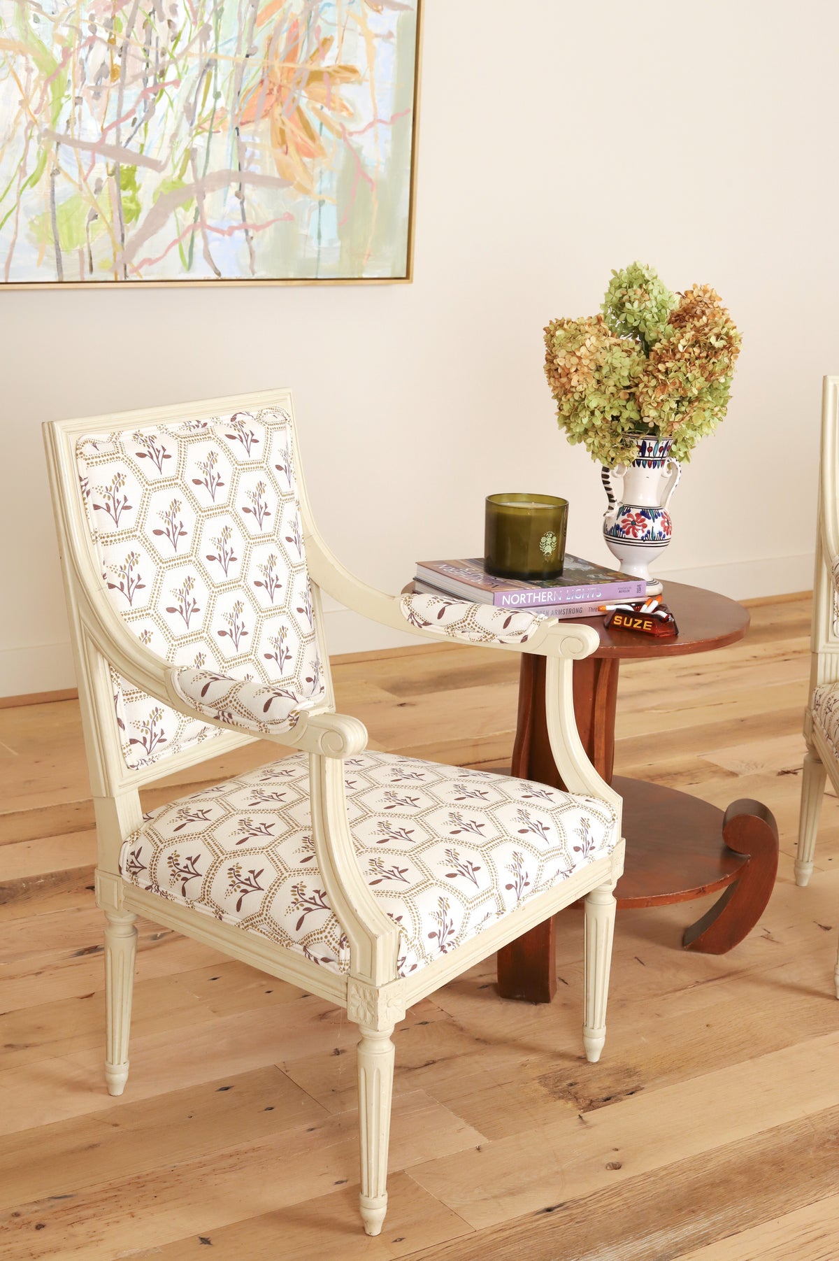 Louis XVI style painted armchair with fluted legs, three-quarter view