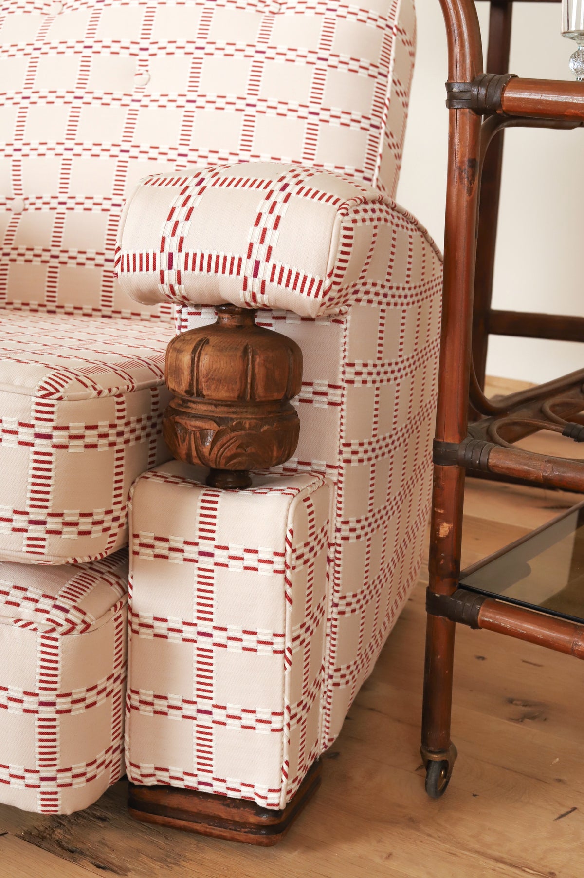 Carved wood arm support detail on a French club chair