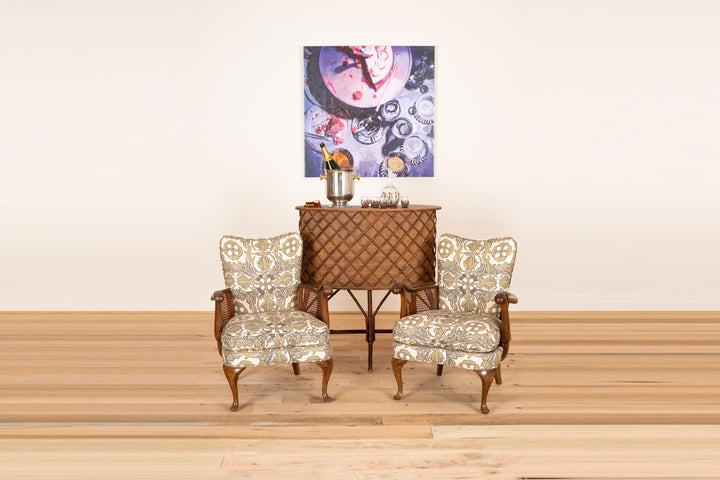 Pair of French sculptural armchairs with cane sides c. 1930 in Otea Vintage Scarf, front view on a wood floor