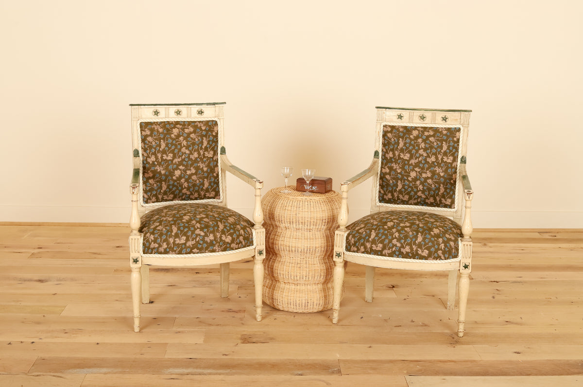 Pair of French painted armchairs in Allem Studio, styled with a rattan side table